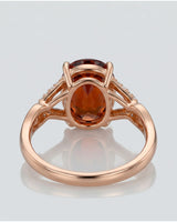 Vivid orange oval garnet ring with natural diamond shoulders in 18K rose gold | SARATTI