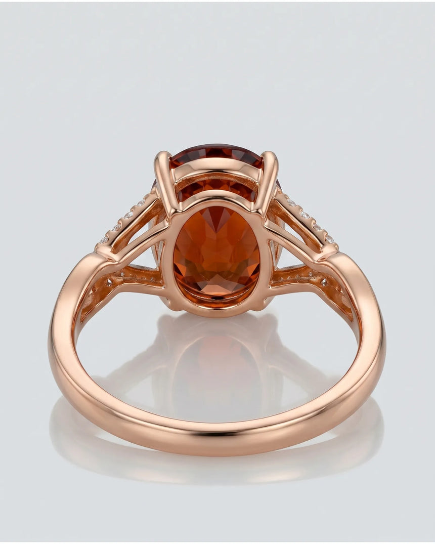 Vivid orange oval garnet ring with natural diamond shoulders in 18K rose gold | SARATTI