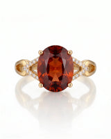 Vivid orange oval garnet ring with natural diamond shoulders in 18K yellow gold | SARATTI