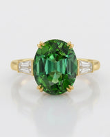 Vivid oval tourmaline ring with emerald-cut diamonds in polished 18K yellow gold | SARATTI