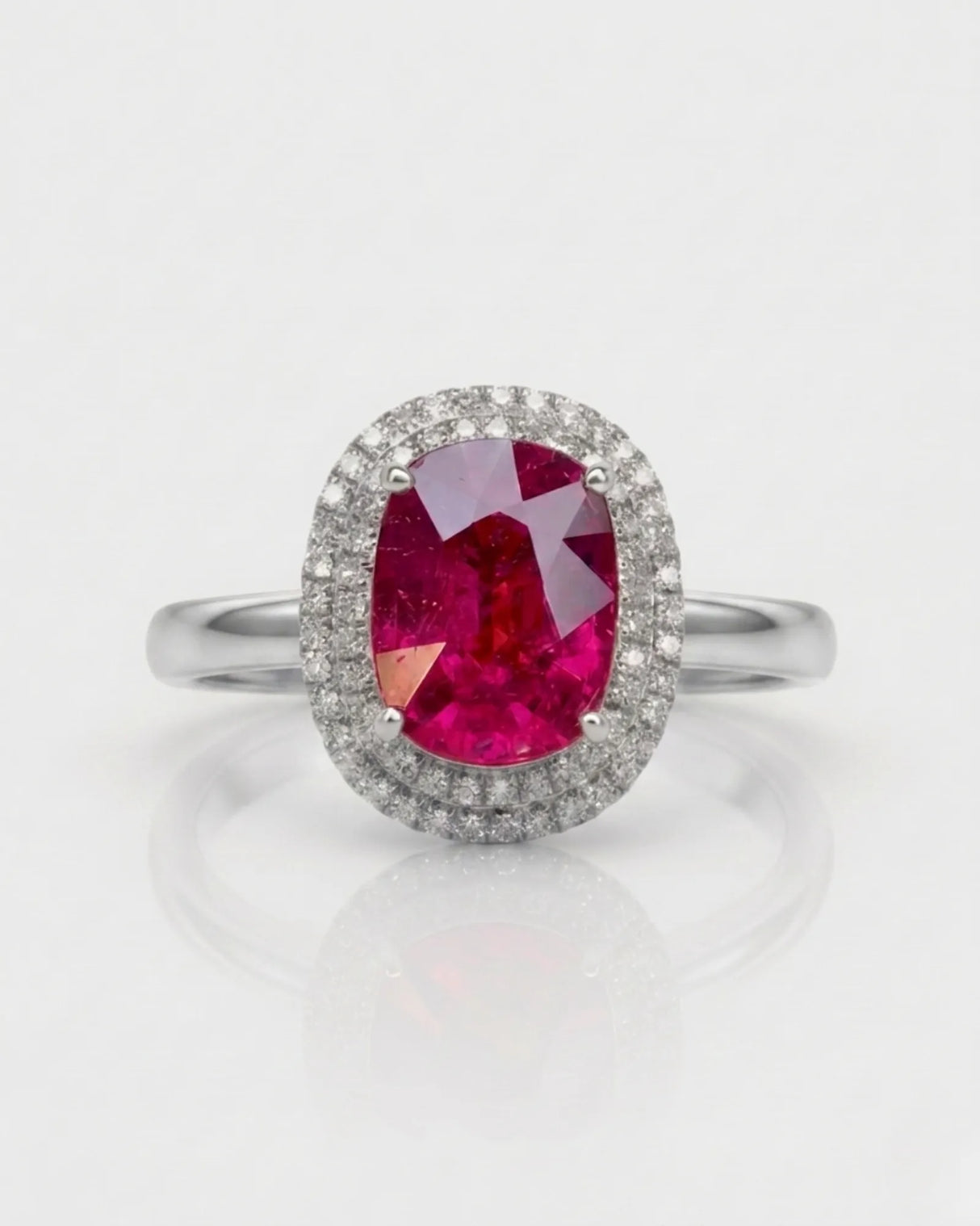Vivid pink oval tourmaline ring framed by natural diamonds in platinum | SARATTI