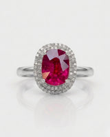 Vivid pink oval tourmaline ring framed by natural diamonds in platinum | SARATTI