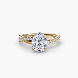 Gold ring with a large diamond and smaller diamonds on the band against a white background - Oval DIamond infinity Setting in 18K Yellow Gold - SARATTI