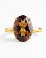 Warm Imperial Topaz engagement ring featuring an oval center and refined 18K yellow gold band | SARATTI