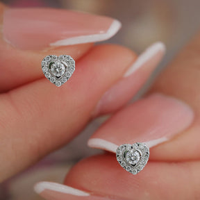 Heart Shaped Halo Tiny Diamond Stud Earrings in Model's Fingers  | Saratti | Custom High and Fine Jewelry