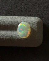 White Opal oval cabochon measuring 12 × 9.6 mm | SARATTI