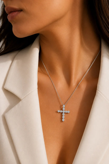 Model wearing the Grande Lueur Croix diamond cross necklace in 18K white gold | SARATTI