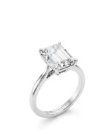 White gold emerald-cut moissanite engagement ring with four-prong solitaire setting and polished band | SARATTI