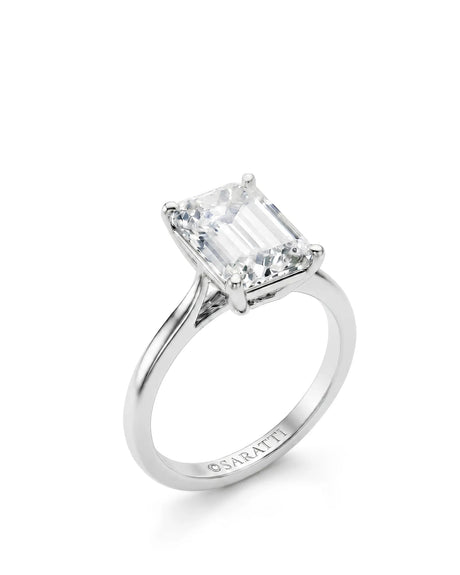 White gold emerald-cut moissanite engagement ring with four-prong solitaire setting and polished band | SARATTI