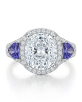 White gold moissanite ring with cushion center, halo, and tanzanite accents | SARATTI