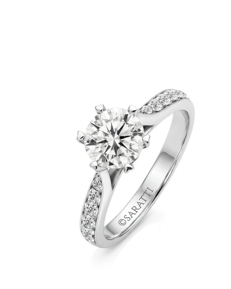White gold round moissanite engagement ring with six-prong crown and pavé shoulders | SARATTI