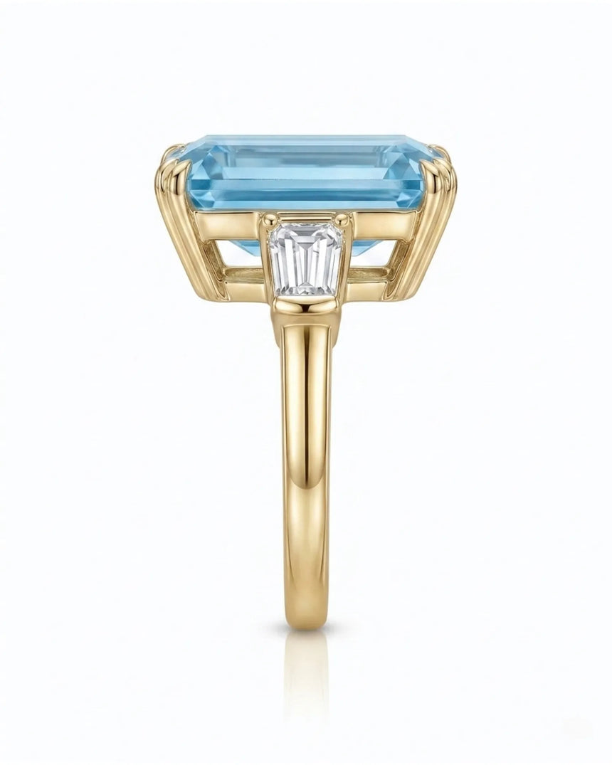 Yellow gold aquamarine ring with emerald cut center and tapered baguette diamond side stones | SARATTI