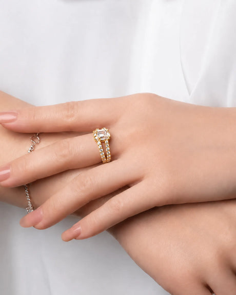 Yellow gold emerald-cut moissanite engagement ring with pavé split shank and four-prong setting | SARATTI.