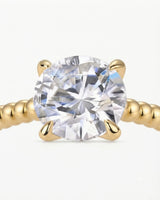 Yellow gold moissanite engagement ring for a warm proposal with distinctive beaded craftsmanship | SARATTI
