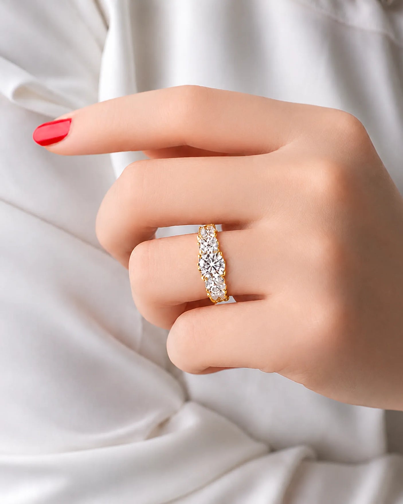 Yellow gold moissanite trilogy ring with graduated side stones and pavé split-shank shoulders | SARATTI