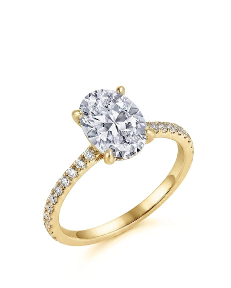 Yellow gold oval moissanite engagement ring with hidden halo and pavé shoulders | SARATTI