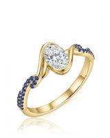 Yellow gold oval moissanite engagement ring with natural blue sapphire accents and flowing bezel design | SARATTI