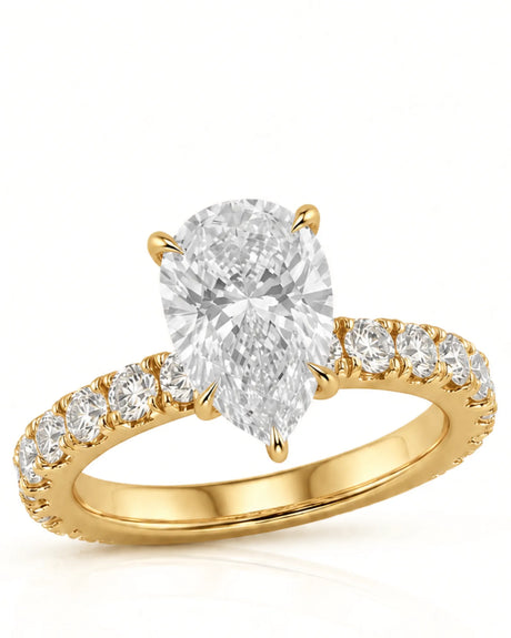 Yellow gold pear cut moissanite engagement ring with round side stones and slim polished band | SARATTI