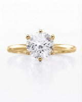 Yellow gold round moissanite engagement ring for a timeless and meaningful proposal | SARATTI
