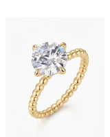 Yellow gold round moissanite engagement ring with polished beaded band and four-prong solitaire setting | SARATTI