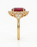 Yellow gold tourmaline ring with floral diamond halo and vivid reddish pink center stone | SARATTI