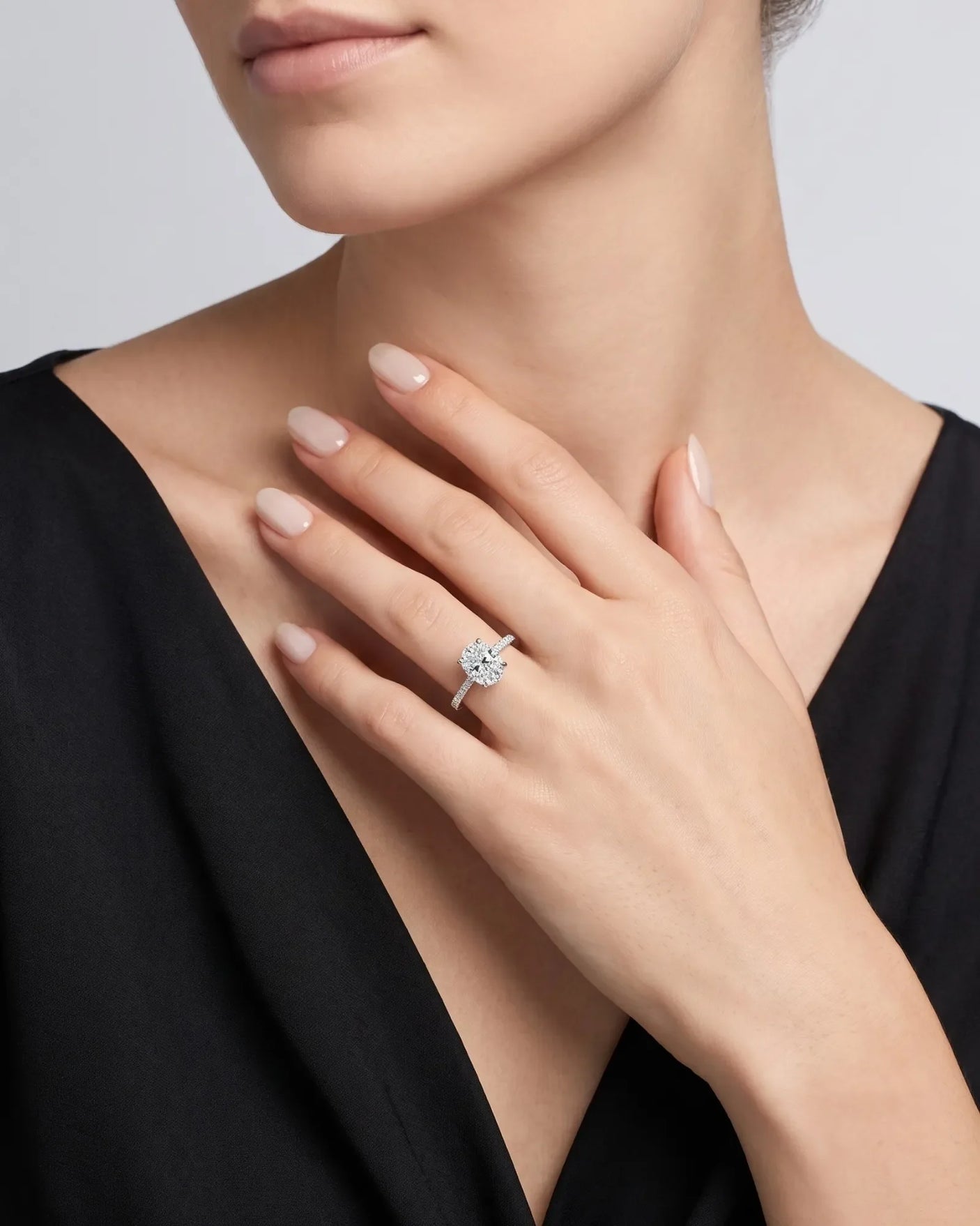Adriana 1 carat F-colour oval natural diamond hidden halo ring in 18K white gold, worn on hand | SARATTI