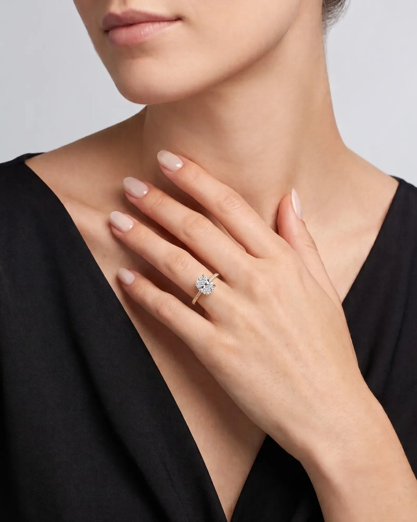Adriana 1 carat F-colour oval natural diamond hidden halo ring in 18K yellow gold, worn on hand | SARATTI