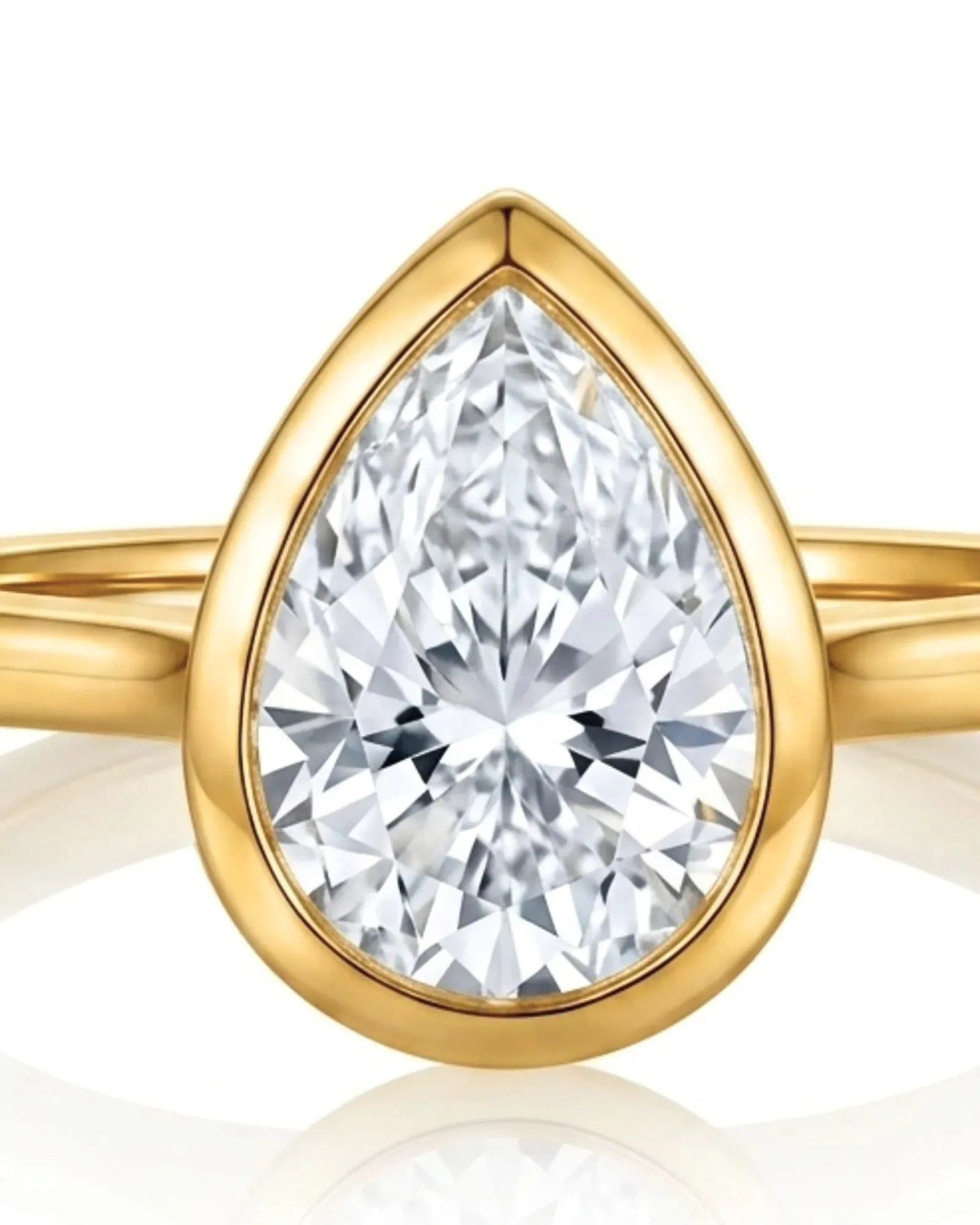 Aurelia's Embrace pear-cut natural diamond bezel engagement ring in 18K yellow gold, close-up of diamond and bezel setting | SARATTI