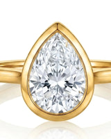 Aurelia's Embrace pear-cut natural diamond bezel engagement ring in 18K yellow gold, close-up of diamond and bezel setting | SARATTI
