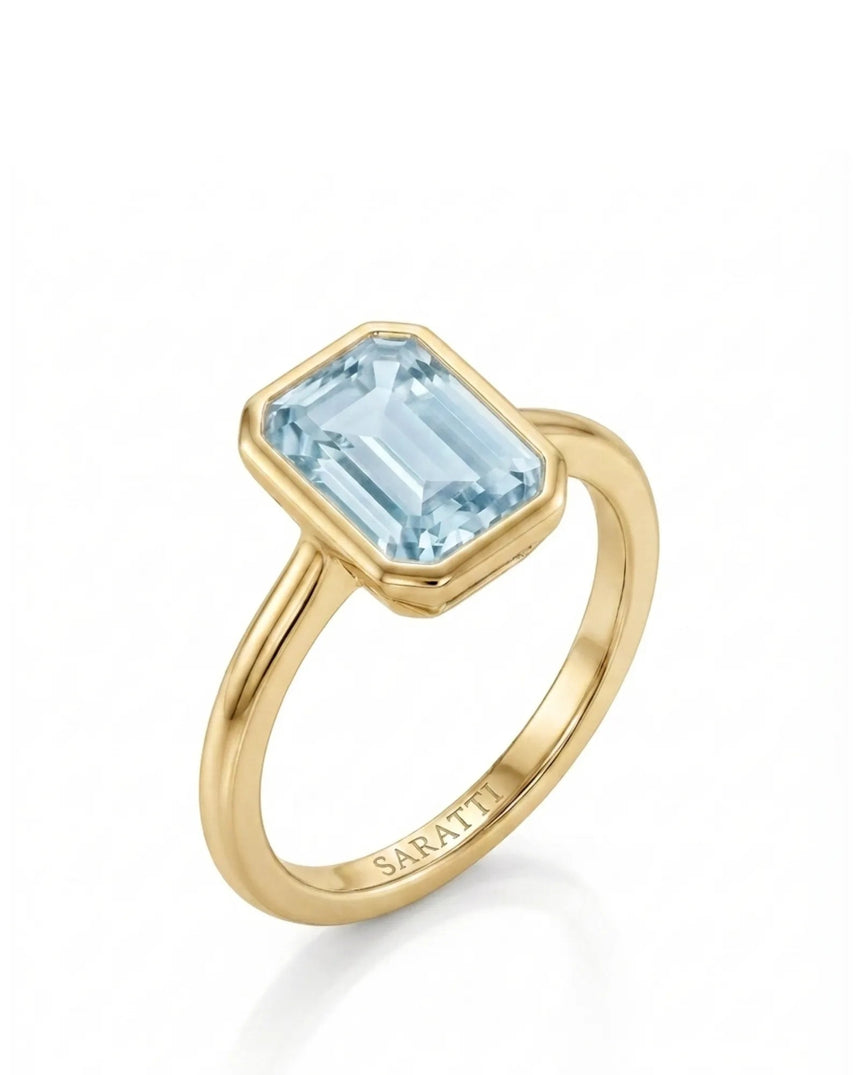 AUREX emerald cut Aquamarine bezel ring setting in Yellow Gold, 45-degree view | SARATTI
