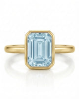 AUREX emerald cut Aquamarine bezel ring setting in Yellow Gold, front view | SARATTI
