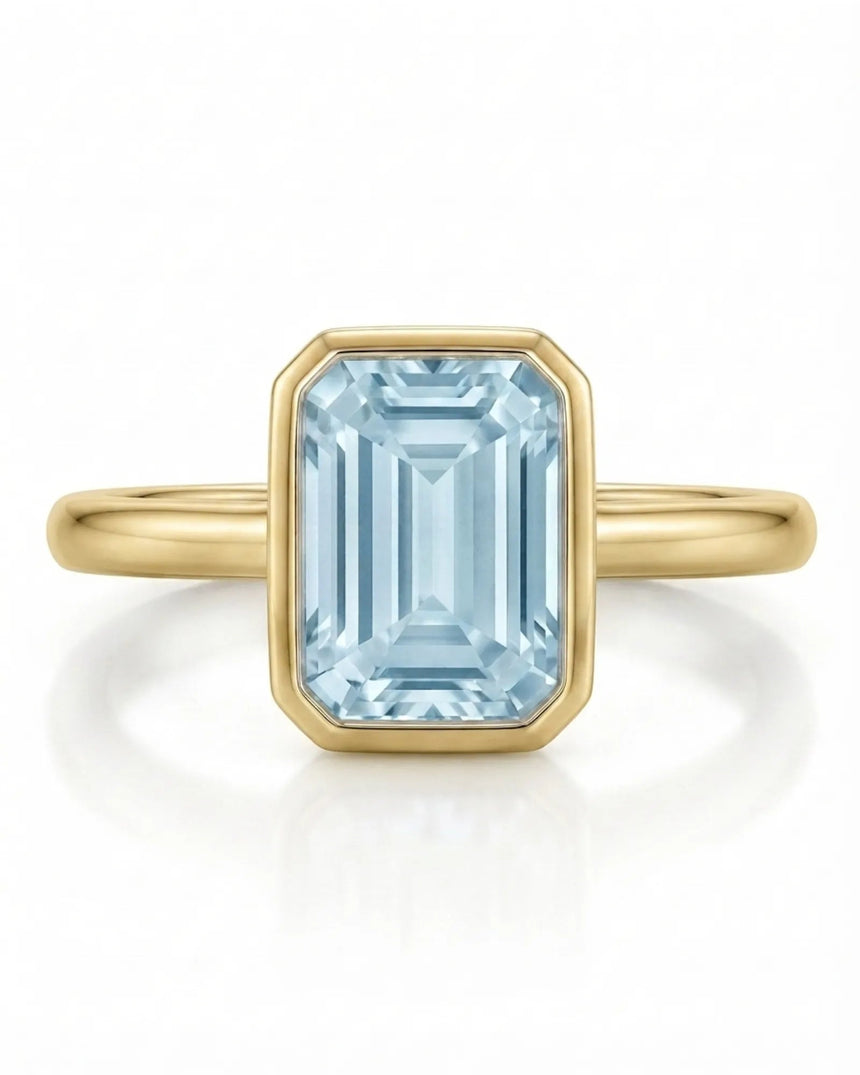 AUREX emerald cut Aquamarine bezel ring setting in Yellow Gold, front view | SARATTI