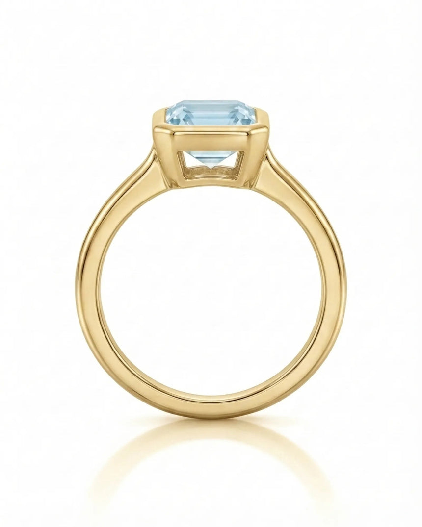 AUREX emerald cut Aquamarine bezel ring setting in Yellow Gold, top view | SARATTI
