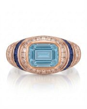 Azzurro Regent emerald-cut Aquamarine cocktail ring setting in rose gold, front view with baguette diamond frame and blue sapphire channels | SARATTI