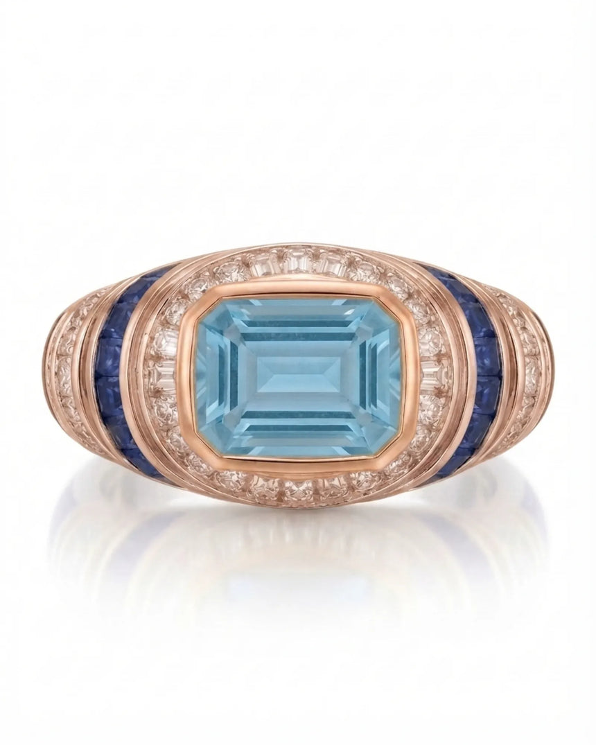 Azzurro Regent emerald-cut Aquamarine cocktail ring setting in rose gold, front view with baguette diamond frame and blue sapphire channels | SARATTI