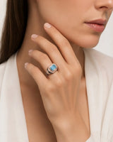 Azzurro Regent emerald-cut Aquamarine sapphire and diamond cocktail ring setting in rose gold, worn on hand | SARATTI