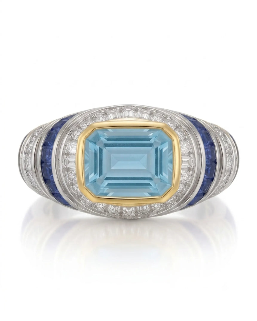 Azzurro Regent emerald-cut Aquamarine cocktail ring setting in yellow and white gold, front view with baguette diamond frame and blue sapphire channels | SARATTI