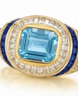 Azzurro Regent emerald-cut Aquamarine cocktail ring setting in yellow gold, close-up of baguette diamonds and channel-set blue sapphires | SARATTI