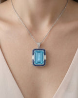 Bleu Meridian emerald-cut Aquamarine sapphire and diamond necklace setting in Platinum, worn at the neckline | SARATTI
