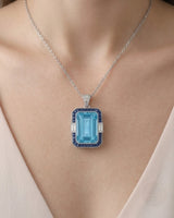 Bleu Meridian emerald-cut Aquamarine sapphire and diamond necklace setting in white gold, worn at the neckline | SARATTI