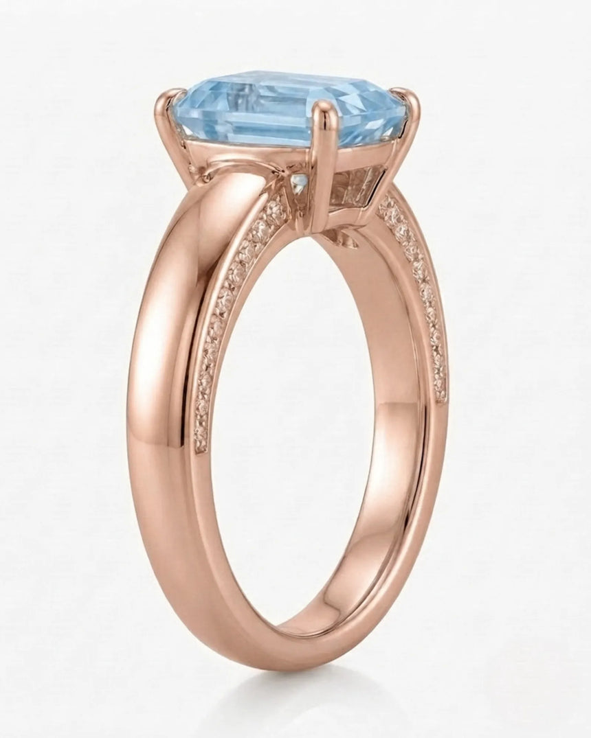 Céleste Arc emerald cut Aquamarine four-prong ring setting in rose gold, front view | SARATTI