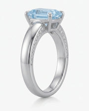 Céleste Arc emerald cut Aquamarine four-prong ring setting in white gold, front view | SARATTI