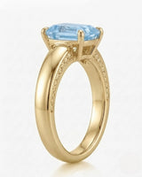 Céleste Arc emerald cut Aquamarine four-prong ring setting in yellow gold, front view | SARATTI