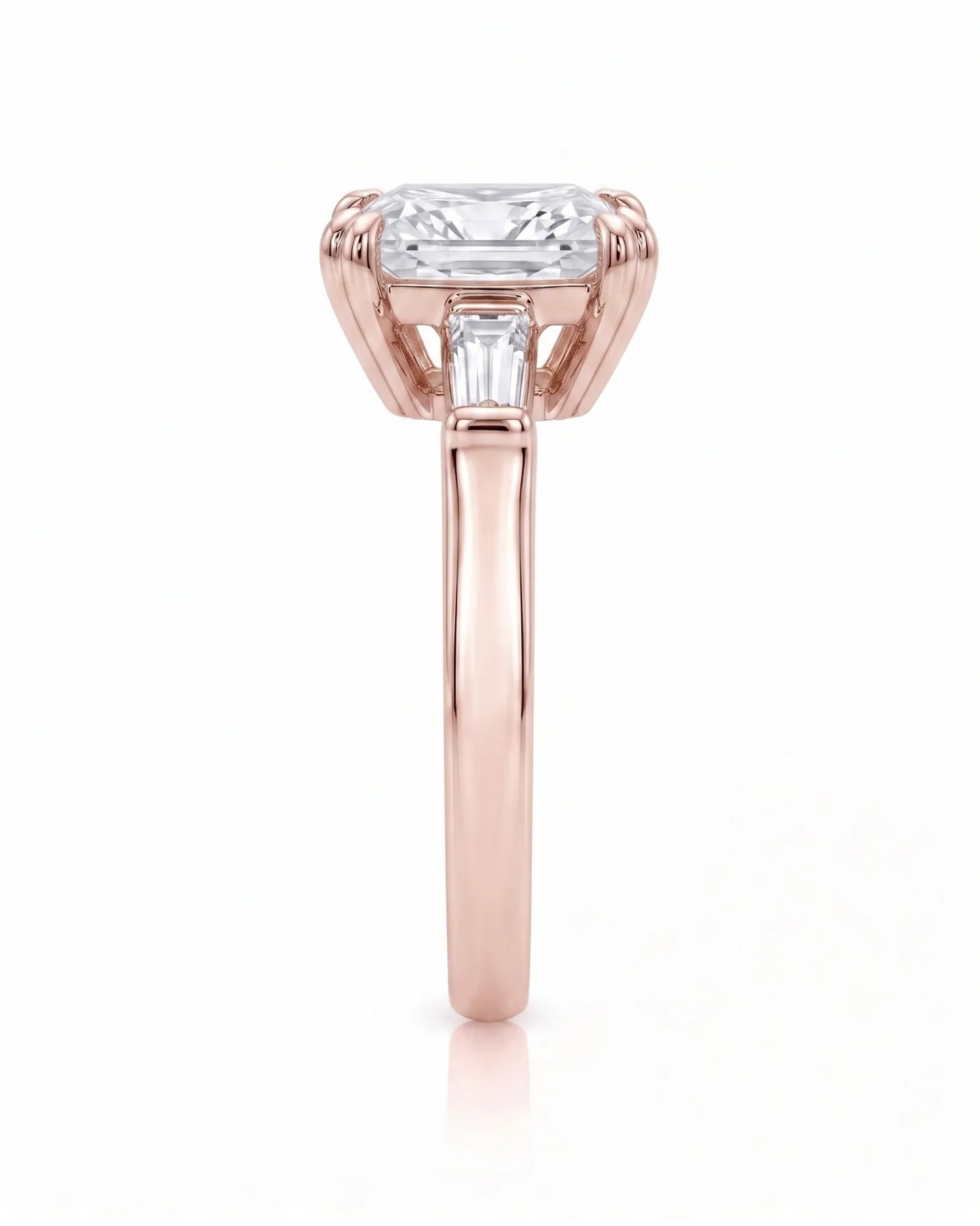 Diane 1 carat F-colour princess natural diamond three-stone ring in 18K rose gold, side profile showing raised open three-stone gallery | SARATTI