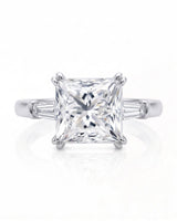 Diane 1 carat F-colour princess natural diamond three-stone ring in 18K white gold, front view of princess centre and tapered side diamonds | SARATTI