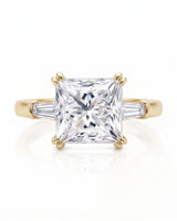 Diane 1 carat F-colour princess natural diamond three-stone ring in 18K yellow gold, front view of princess centre and tapered side diamonds | SARATTI