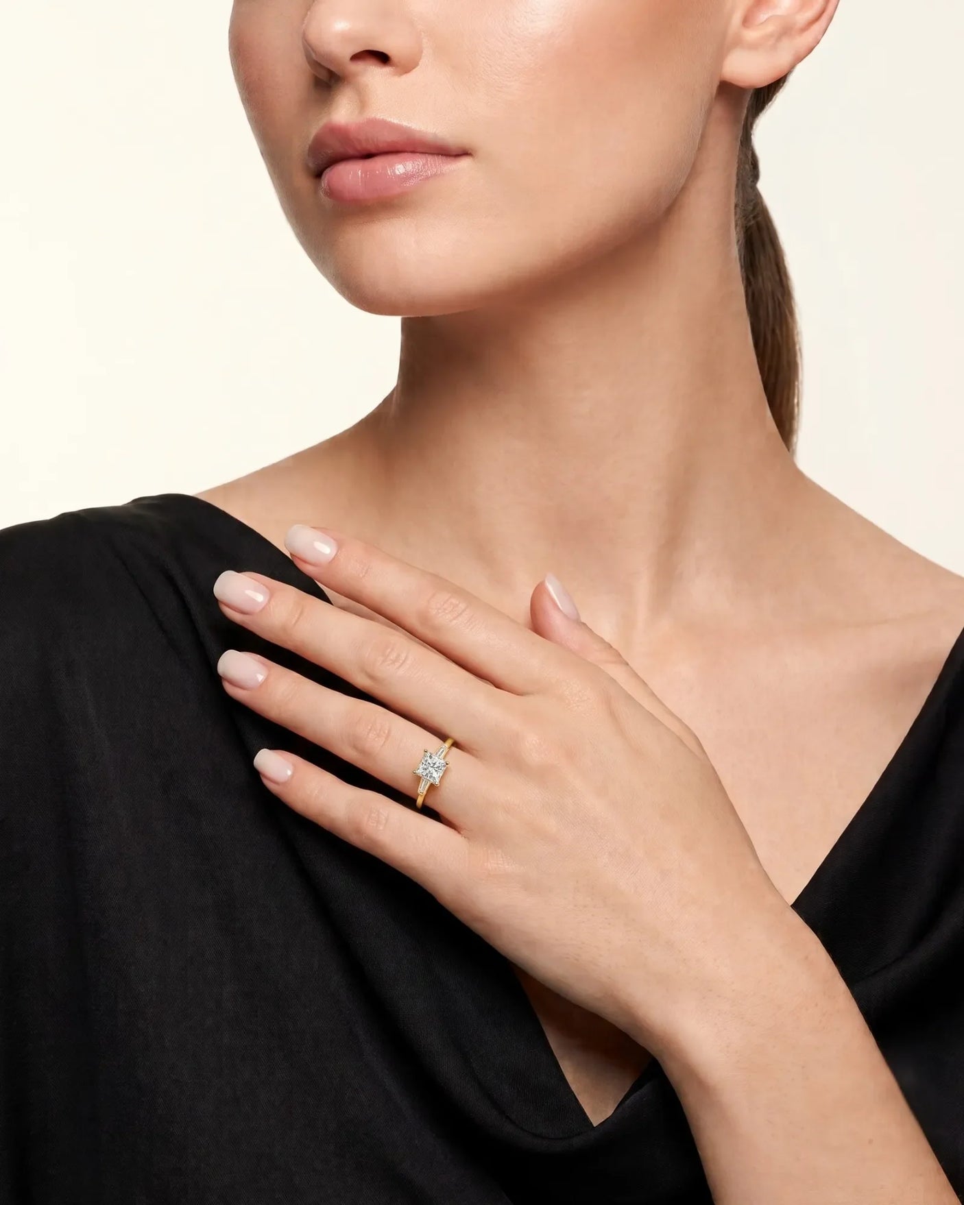 Diane 1 carat F-colour princess natural diamond three-stone ring in 18K yellow gold, worn on hand | SARATTI