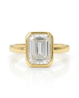 2 carat GIA-certified natural emerald cut diamond bezel ring front view in yellow gold | SARATTI