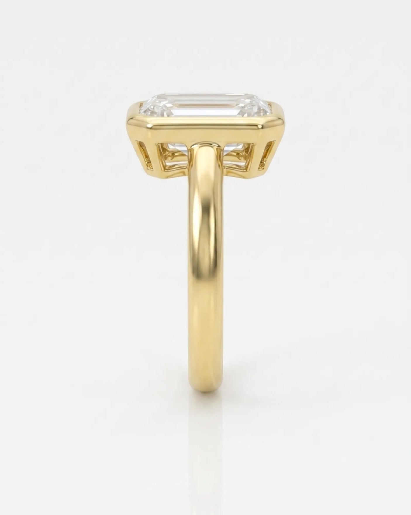 Golden Horizon natural emerald cut diamond bezel engagement ring in yellow gold side profile | SARATTI