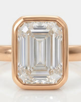 Natural emerald cut diamond full bezel ring in rose gold close-up | SARATTI